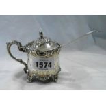A Victorian silver ornate flip-top mustard pot with hinged lid and cast C-scroll decoration,