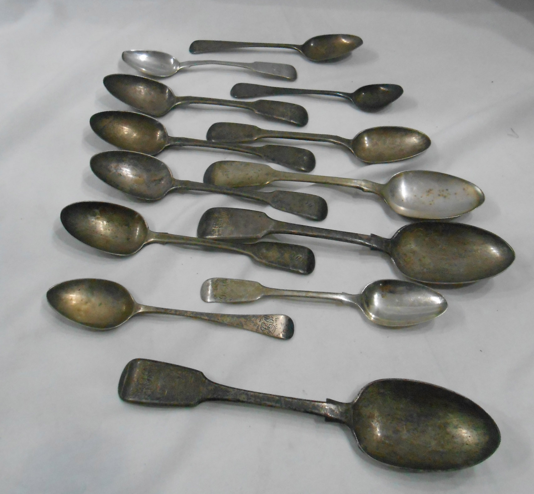 A bag containing five Exeter silver fiddle pattern teaspoons, other teaspoons and three dessert
