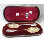 A cased pair of Walker & Hall silver shell and fiddle pattern berry spoons with remains of parcel