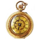 A marked 14k yellow metal cased lady's fob watch with decorative dial and crown wind lever