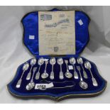 A cased set of twelve silver fiddle pattern teaspoons with ornate engraved cut style decoration
