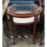 A 60cm reproduction mahogany and strung oval table vitrine with material lined interior, set on