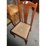 A set of four antique mahogany Queen Anne style dining chairs with pierced splat backs and drop-in