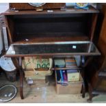 A 70cm 20th Century mahogany bookcase with mirrored shelf to front surface, set X-framed standard