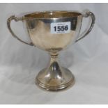 A 17cm high silver two handled trophy cup for the 'Bratton Clovelly Races 1934 and 1935,' set on a