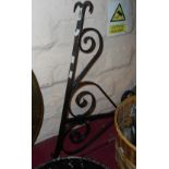 A large wrought iron sign bracket with black painted finish