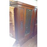A 1.13m late Victorian stained walnut wardrobe with hanging space enclosed by a bevelled mirror
