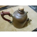 An old copper coffee pot with brass tap to front, cork top and Bakelite handle