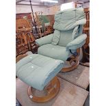 A Stressless reclining easy chair with pale green material upholstery, set on a polished bentwood