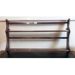 A 92cm Ercol wall hanging two shelf open plate rack with shaped ends - finish worn