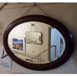 An early 20th Century mahogany and strung framed bevelled oval wall mirror