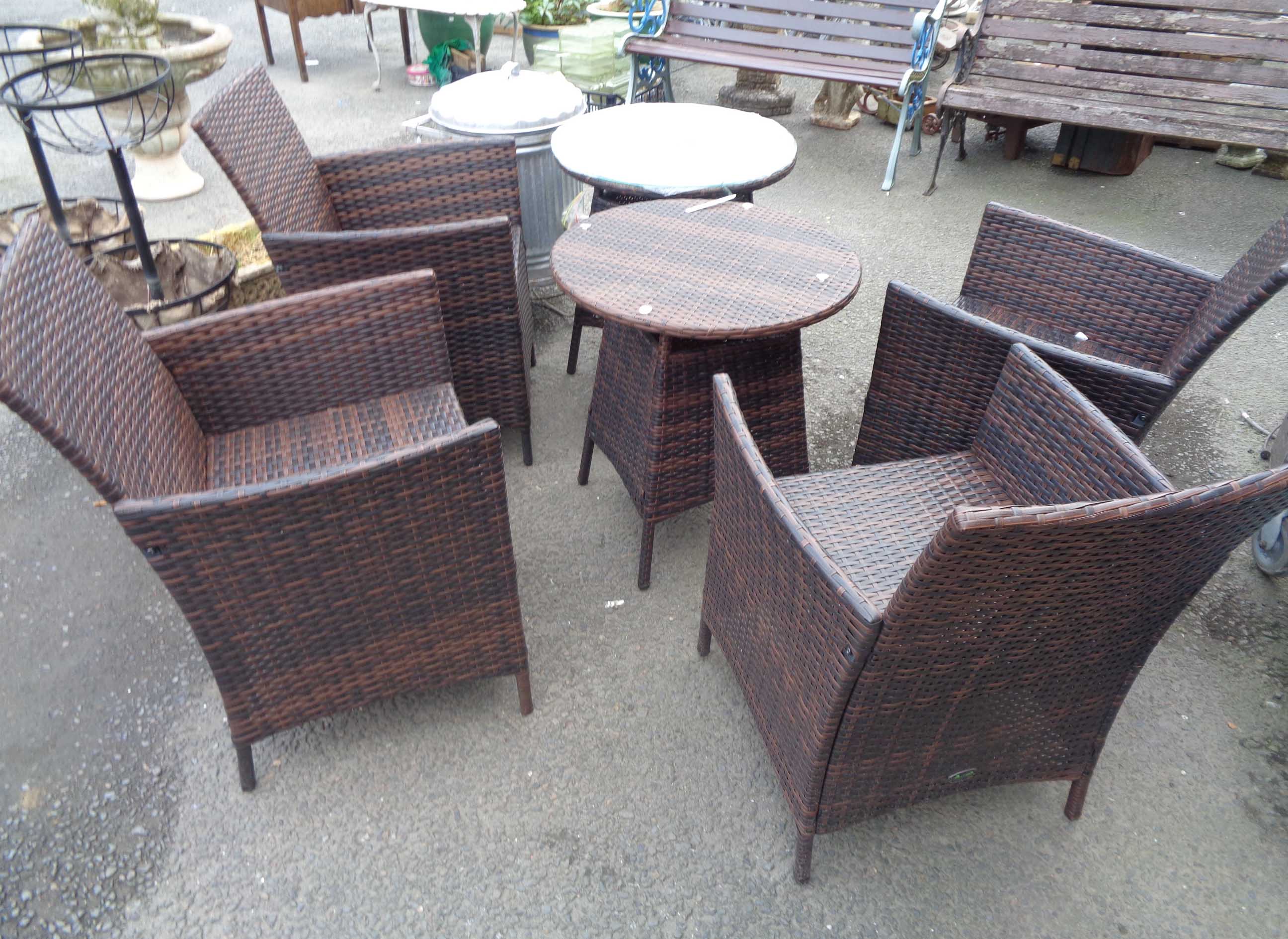 A rattan effect Chelsea Garden Co. outdoor furniture patio set comprising four chairs and two