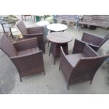 A rattan effect Chelsea Garden Co. outdoor furniture patio set comprising four chairs and two