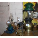 A vintage Tilley lamp sold with three small oil lamps and a primus style stove.