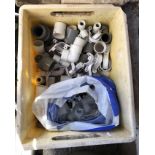 A crate containing assorted plastic and copper plumbing bends