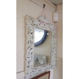A reproduction painted wood framed oblong wall mirror with ornate carved and pierced acanthus scroll