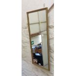 A gilt framed narrow oblong wall mirror
