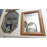 A modern decorative framed octagonal wall mirror - sold with a modern pine framed similar