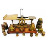 A set of Victorian brass postal scales set on wooden base By Samson Mordan & Co - sold with a tub of