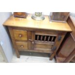 A 77.5cm polished oak livery cabinet in the antique style with spindle set door and two drawers, set
