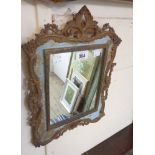 A Victorian style ornate cast brass framed wall mirror with pierced border and square plate