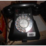 An old GPO Bakelite telephone with front pull out drawer.