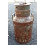 An old galvanised milk churn and lid with brass numbering to side