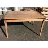 An old pine farmhouse table with plank top and turned legs