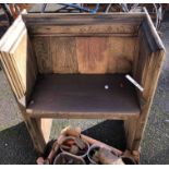 A small single seat bench - formed from an old church pew