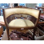 An Edwardian inlaid mahogany framed tub chair with lathe sides and upholstered top rail and seat,