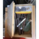 A wooden box containing a quantity of assorted tools