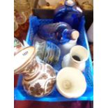 A crate containing a small quantity of ceramic and glass items including blue bottles, etc.
