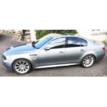 A 2006 BMW M5 four door saloon car in metallic grey with V10 5Litre petrol engine and 38,650