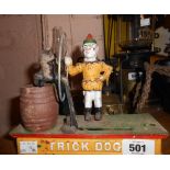 A modern painted cast iron novelty moneybox of 'Trick Dog' form.