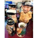 A quantity of Royal Doulton Toby jugs of various size comprising The Huntsman, Happy John, Sir