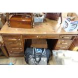 A 1.55m vintage oak desk with blind frieze drawer and flanking slides with seven auto-locking