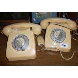 Two vintage telephones in ivory livery