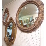 Three ornate gilt plaster framed wall mirrors, comprising a convex, a Rococo style and another