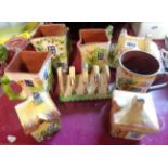 A quantity of Torquay pottery cottageware items comprising set of three graduated jugs, cheese dish,