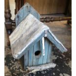 An old folk art bird box of plank construction with lead roof