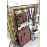 A large modern antiqued gilt framed bevelled oblong wall mirror