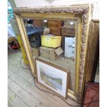 A large old ornate framed bevelled oblong wall mirror with decorative moulded border - some gesso