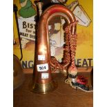 A modern copper and brass bugle with tri-colour bugle cord