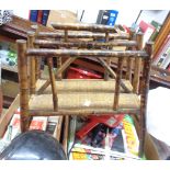 A late Victorian bamboo two section magazine rack with woven surface panel