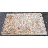 A Chinese washed wool rug with Autumnal foliate decoration on pale green ground - staining - 1.55m X