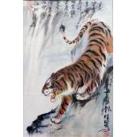 An ebonised framed Japanese watercolour, depicting a tiger prowling around the edge of a waterfall -