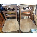 Two old oak framed chapel chairs with solid sectional seats, set on simple turned supports