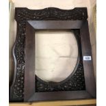 An old carved wooden frame with grape and vine decoration - sold with another old wooden frame