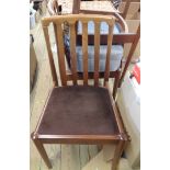 A set of four retro Meredew teak framed dining chairs with upholstered seats, set on simple turned