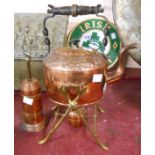 An old copper spirit kettle with embossed floral decoration, set on brass stand - sold with a copper
